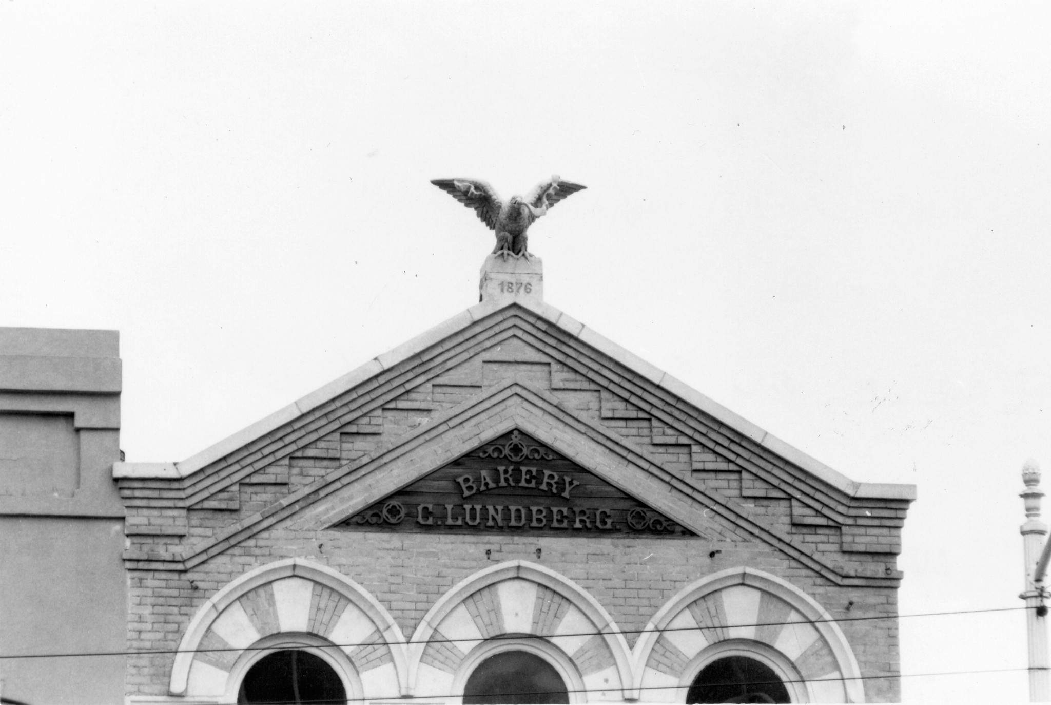 historic building in black and white featuring statue of eagle