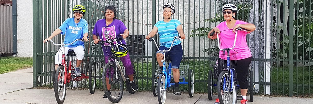 Seniors riding three wheel bikes
