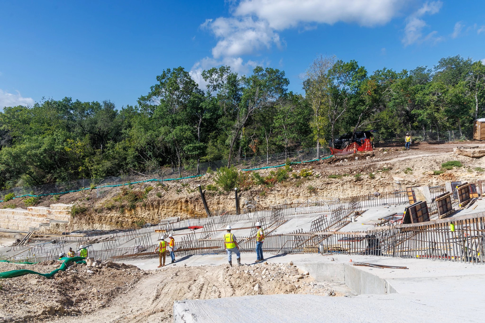 Image of work area for Old Lampasas Dam Modernization project featuring contractor staff alongside the dam's spillway.