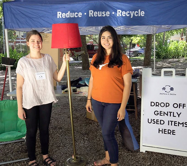 Two women volunteer at a MouveOutATX donation station
