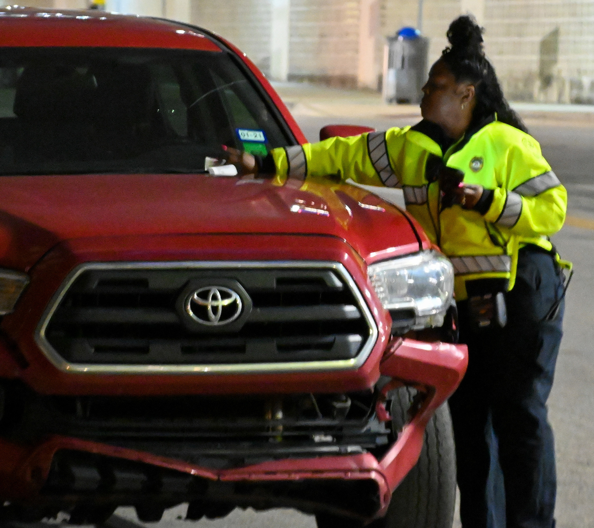 Mobility Services Officers places ticket on vehicle for no active parking session.