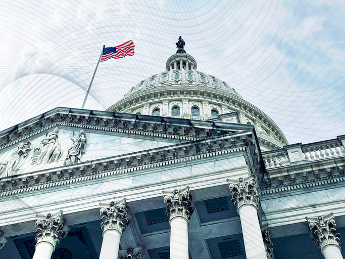 The United States Capitol building dome and facade with an American flag