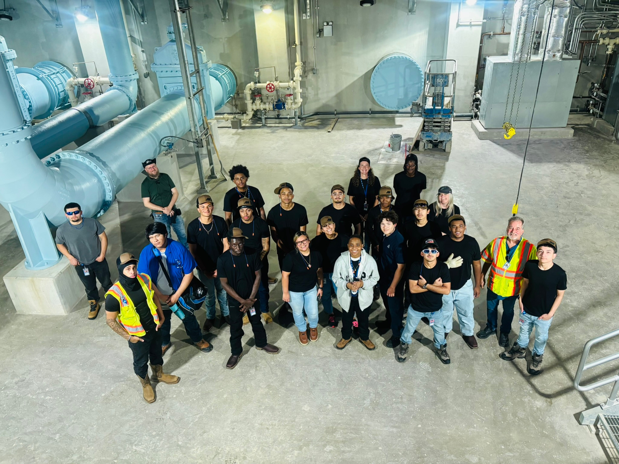 Participants in the Austin Water Talent Apprenticeship Program posing for a photo inside a water treatment facility.