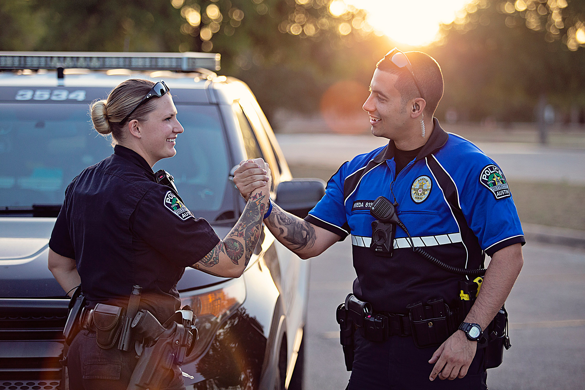 Two Austin Police Officers smiling and shaking hands
