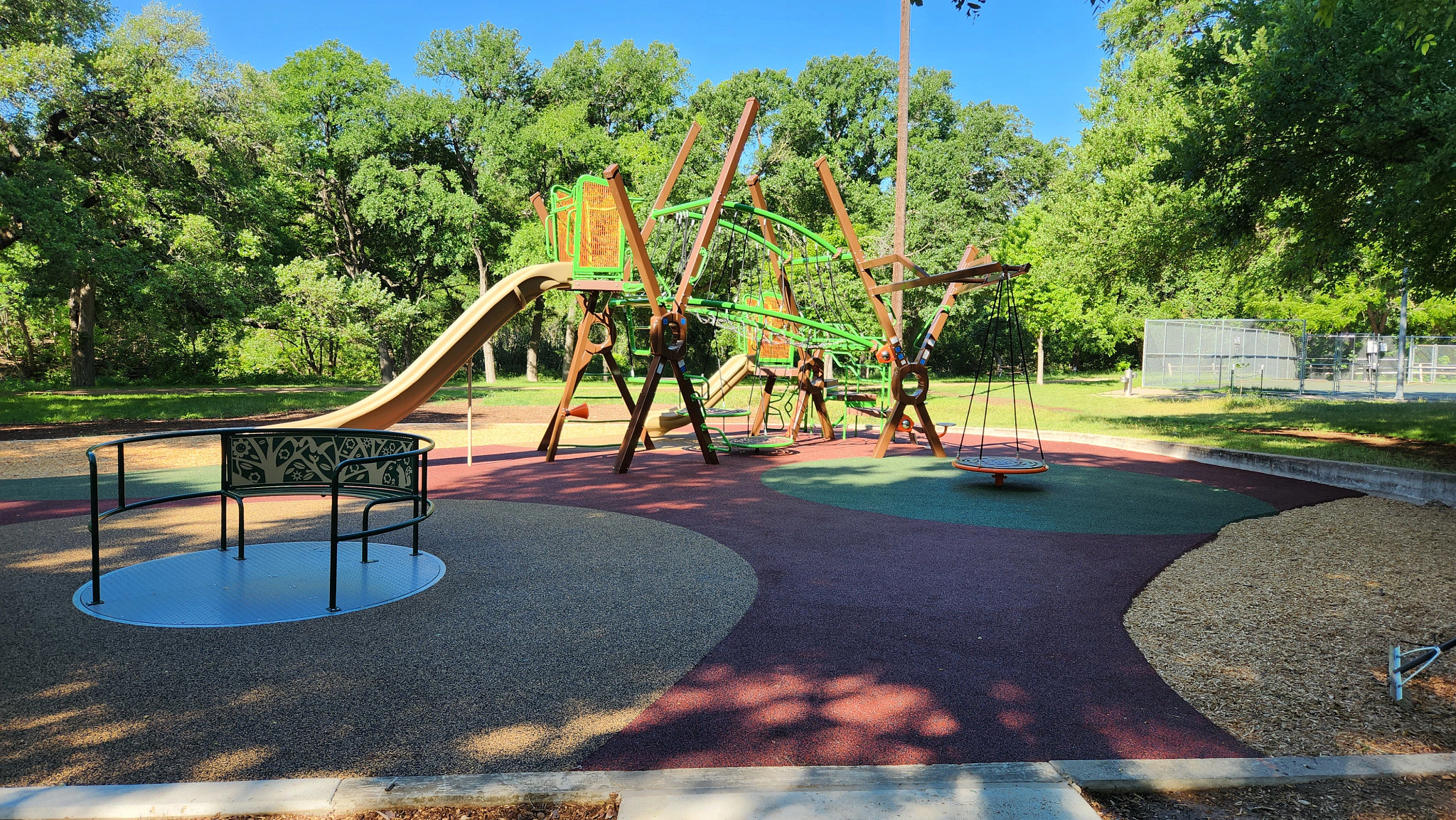 Playscape including climbing features, large swing and slides at Dottie Jordan Neighborhood Park