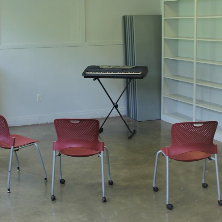 Room at the Dougherty Arts Center with chairs and an electric keyboard