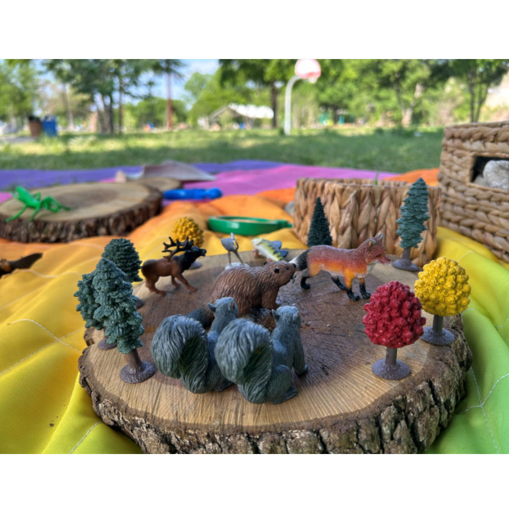 Toys arranged on a slice of log
