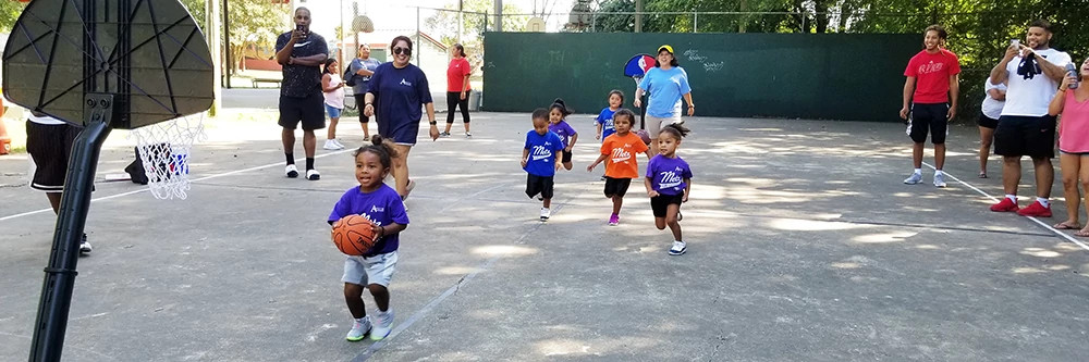 toddlers playing basketball