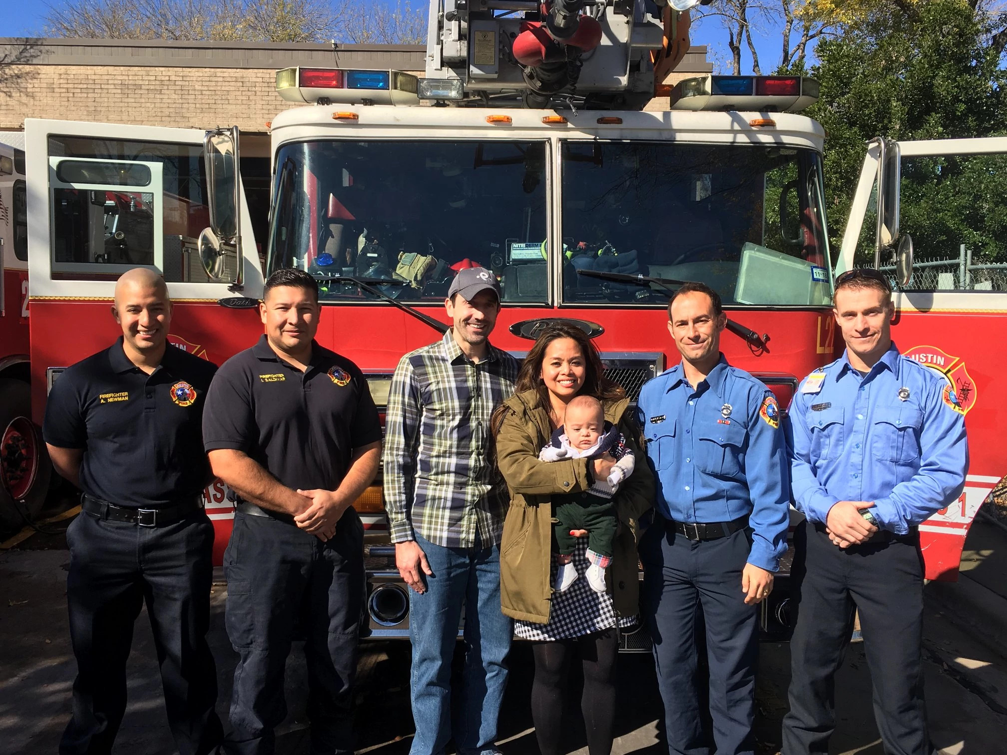 Smiling AFD employees in front of AFD Engine