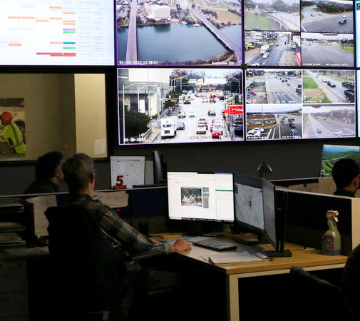 Staff monitor traffic signals and closed circuit television cameras to manage Austin's street network.