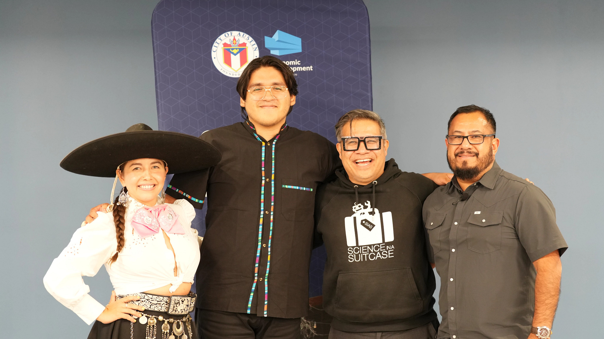 Four people pose for a group photo