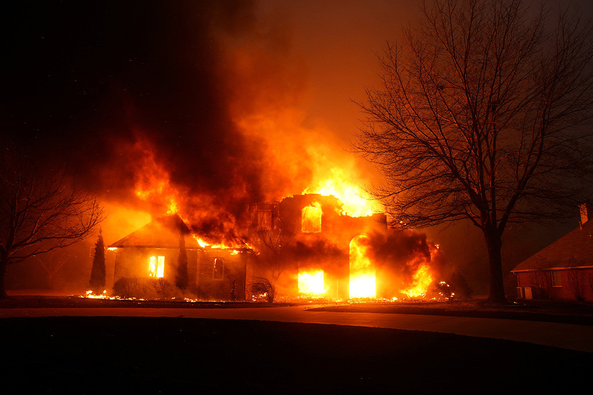 A house at night on fire.