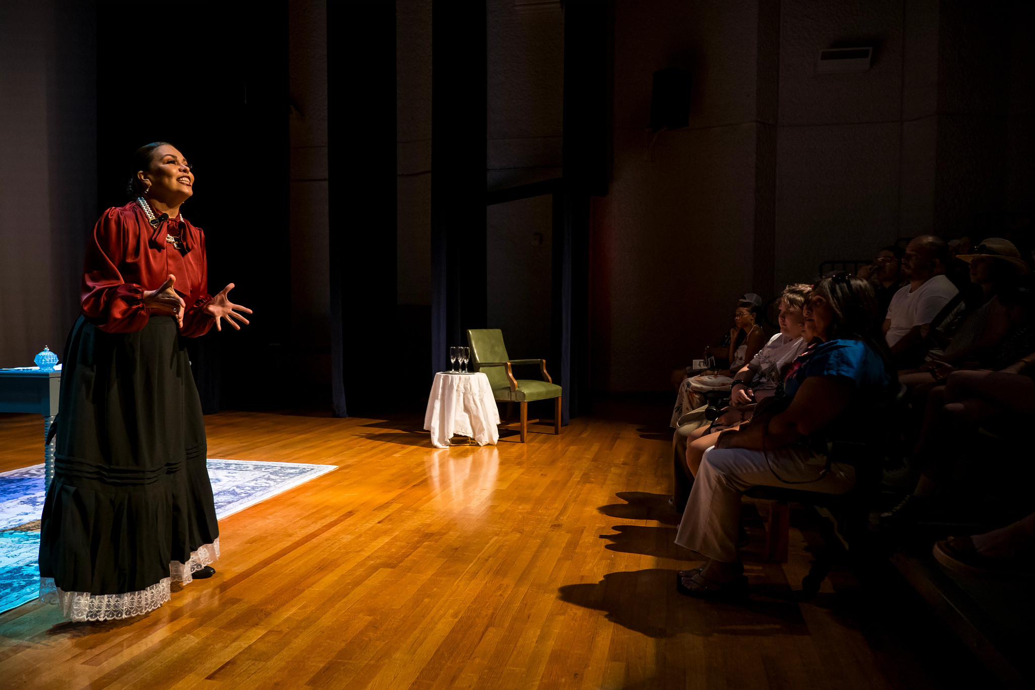 woman acting out a scene in front of an audience