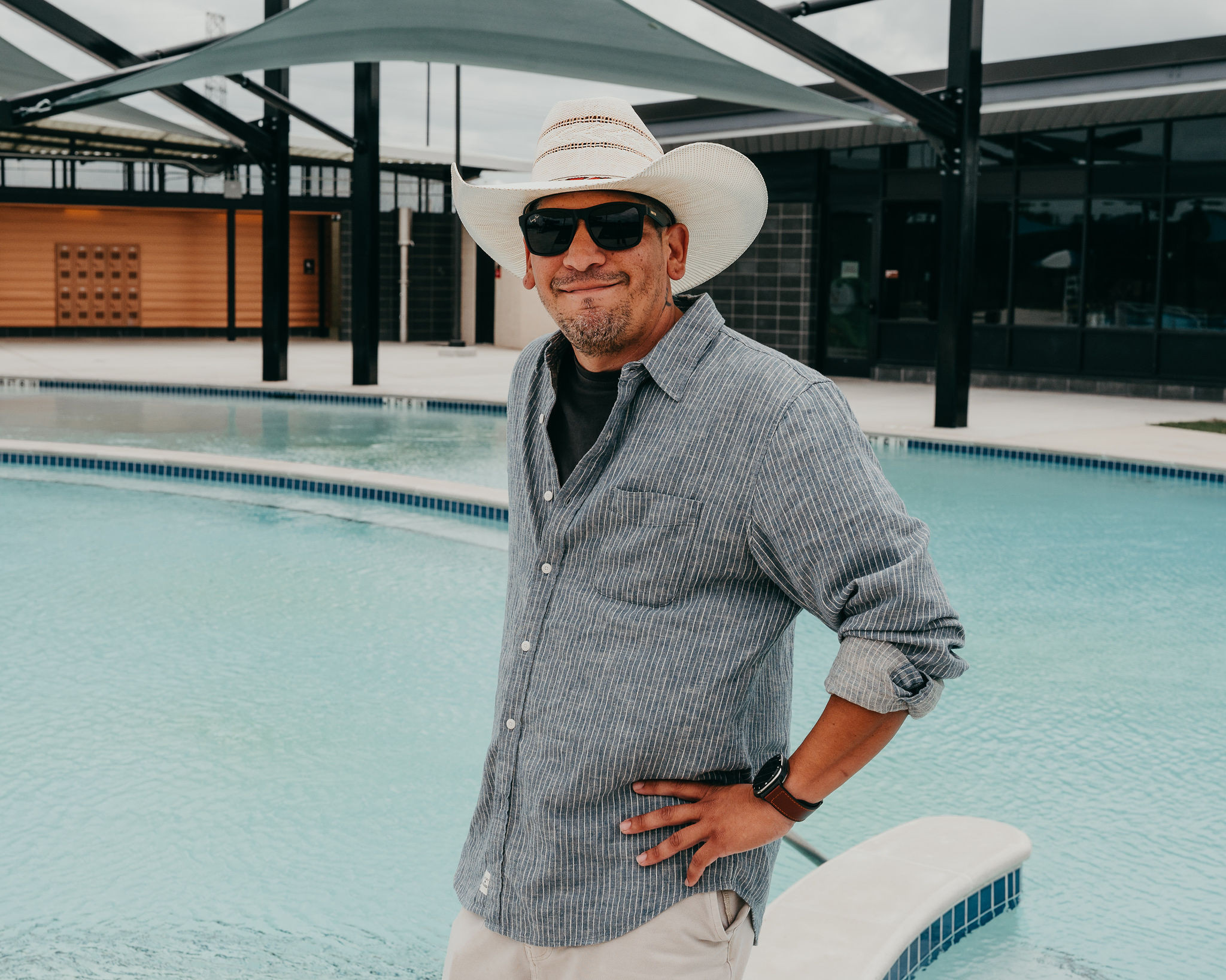 Staff Justin Davis standing in front of a pool