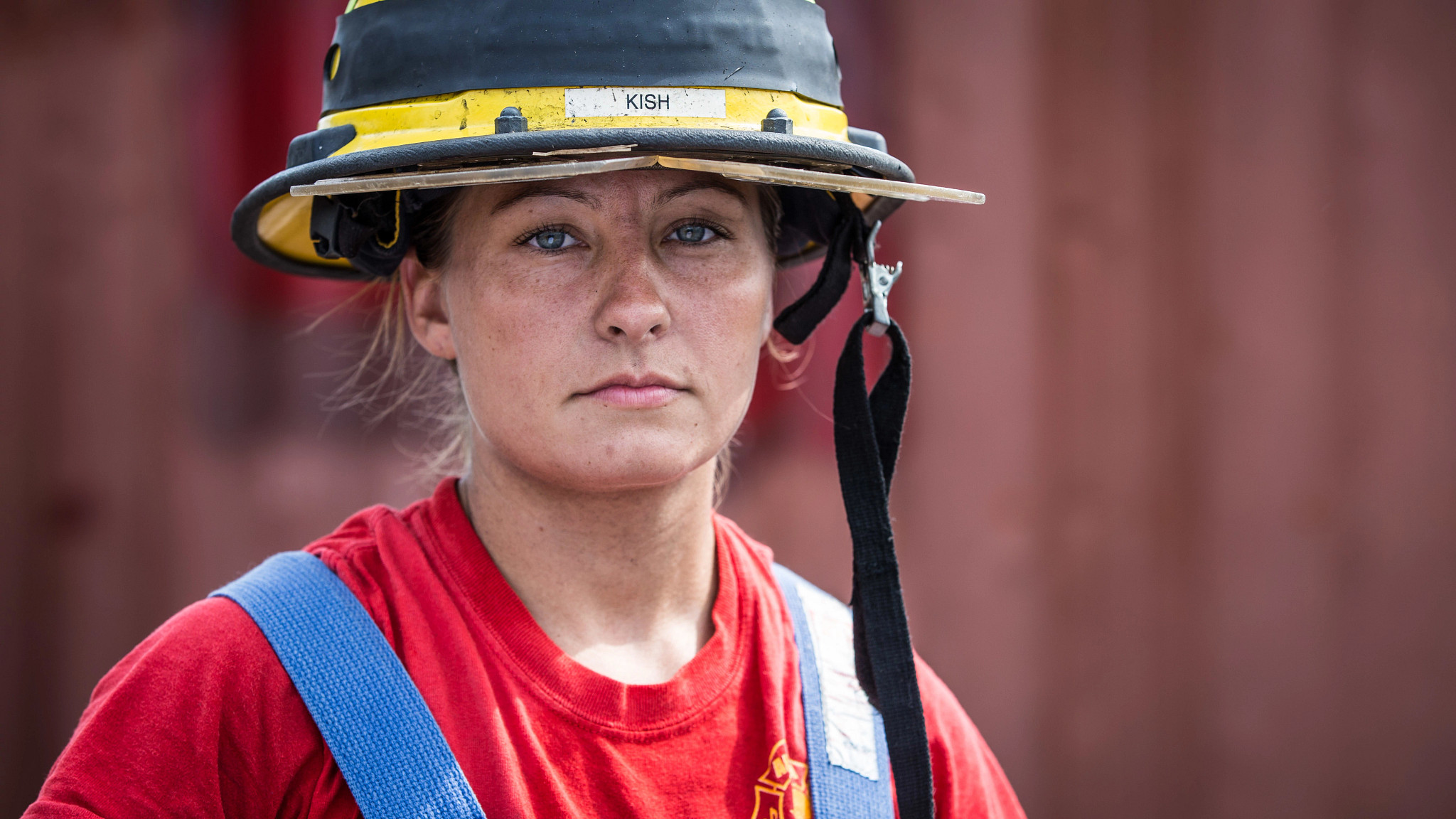 Female firefighter in uniform looking at camera