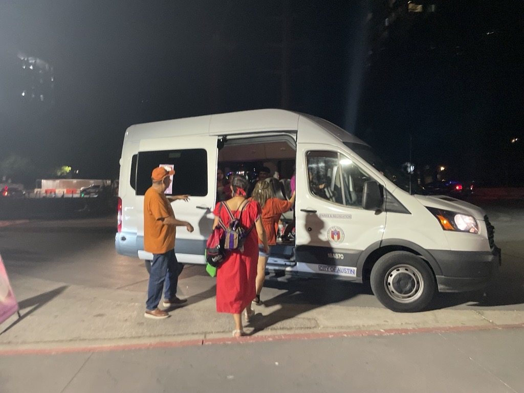 ESB MACC Viva Mexico Shuttle Bus with people getting on in the dark