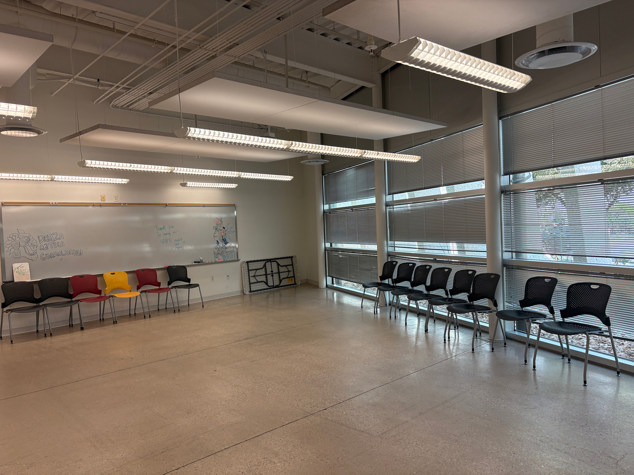 empty room with gray vinyl flooring, white walls, and whiteboard