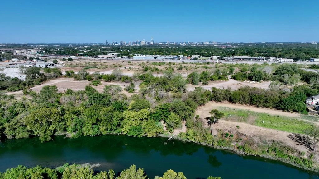 Aerial view of Bolm Park with Colorado River in foreground and Austin skyline in background