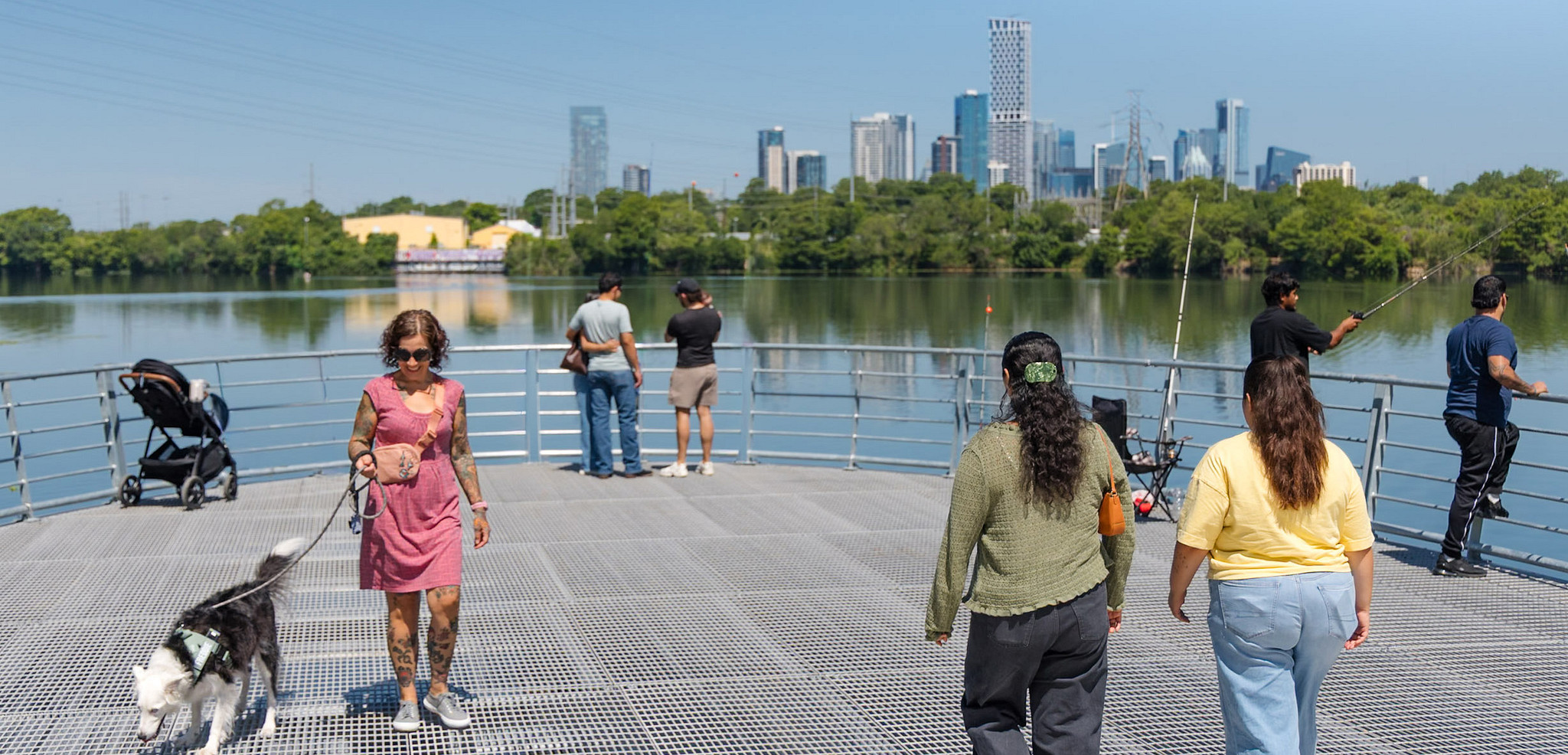 People gather on the overlook on Lady Bird Lake near the new Wishbone Bridge at Longhorn Dam.