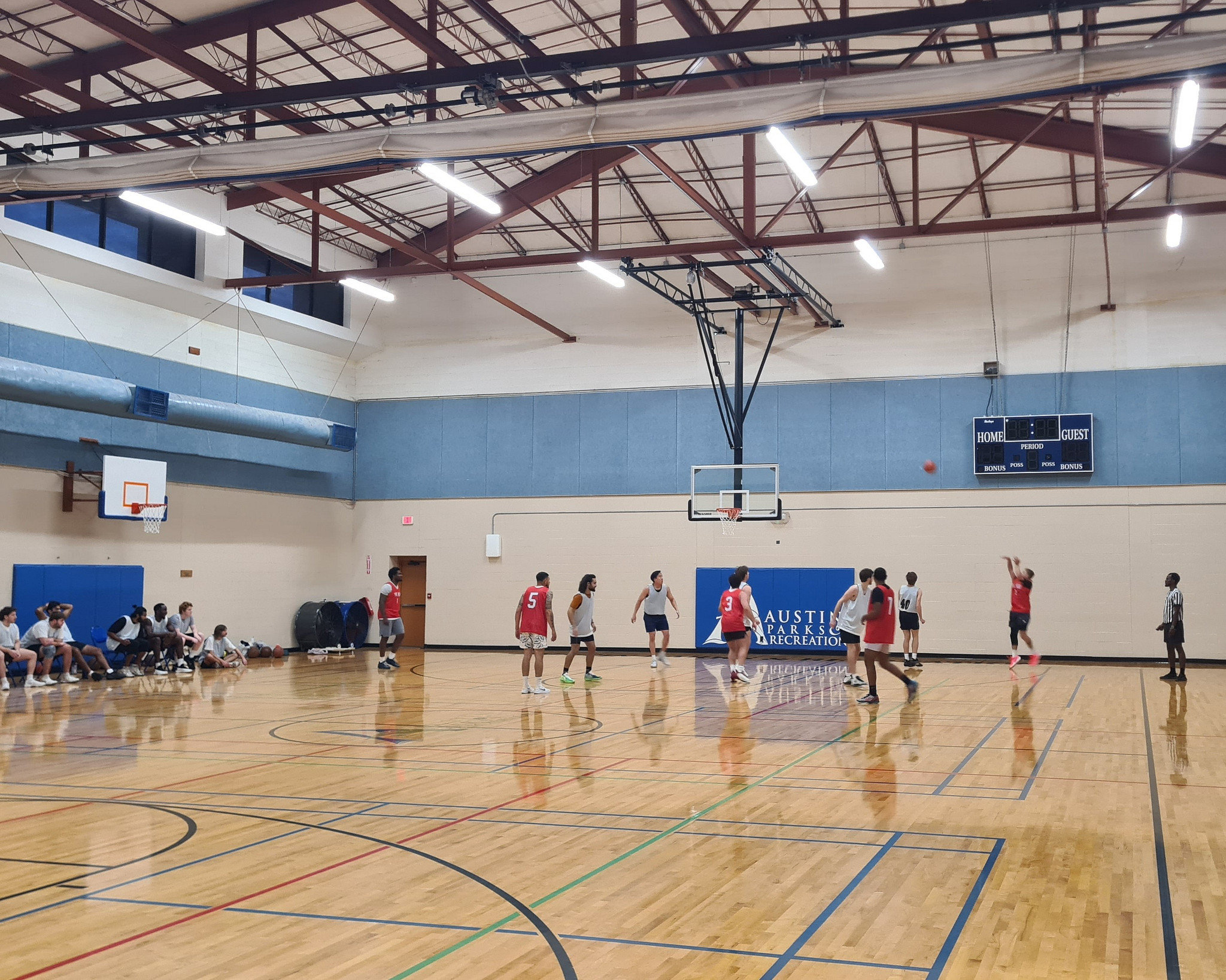 Adult indoor basketball teams playing in the Austin Recreation Center gym