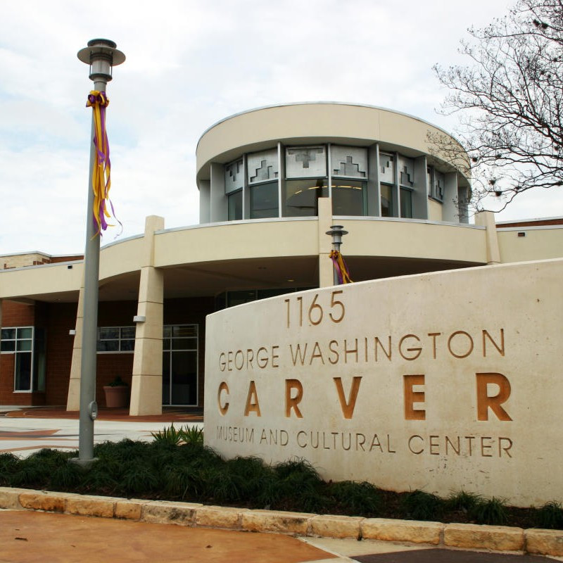 Exterior of the George Washington Carver Museum and Cultural Center with its stone entrance sign.