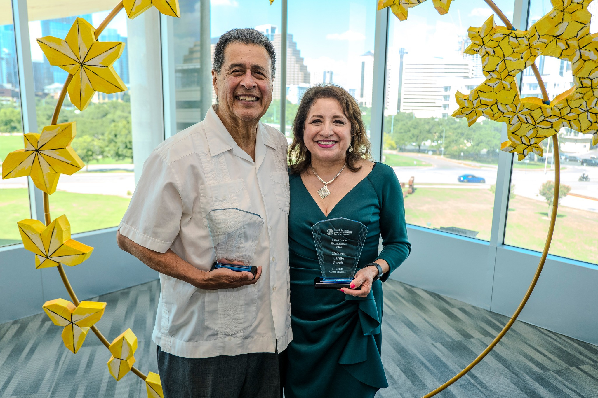 MACC Awards of Excellence Awardees 2024 photo of two smiling award recipients, one make and one female 