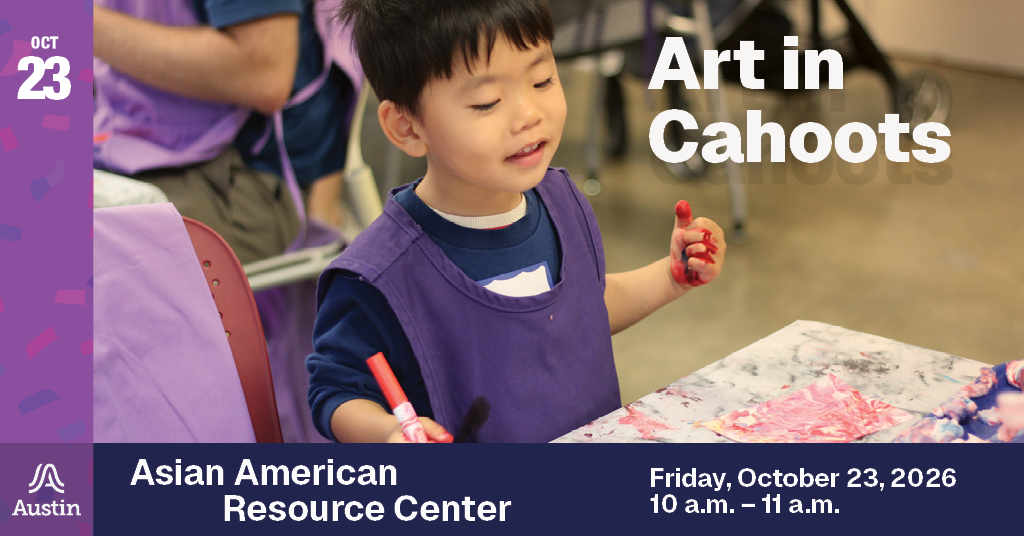 Picture of a child smiling and holding a marker, looking down at a table with artwork.