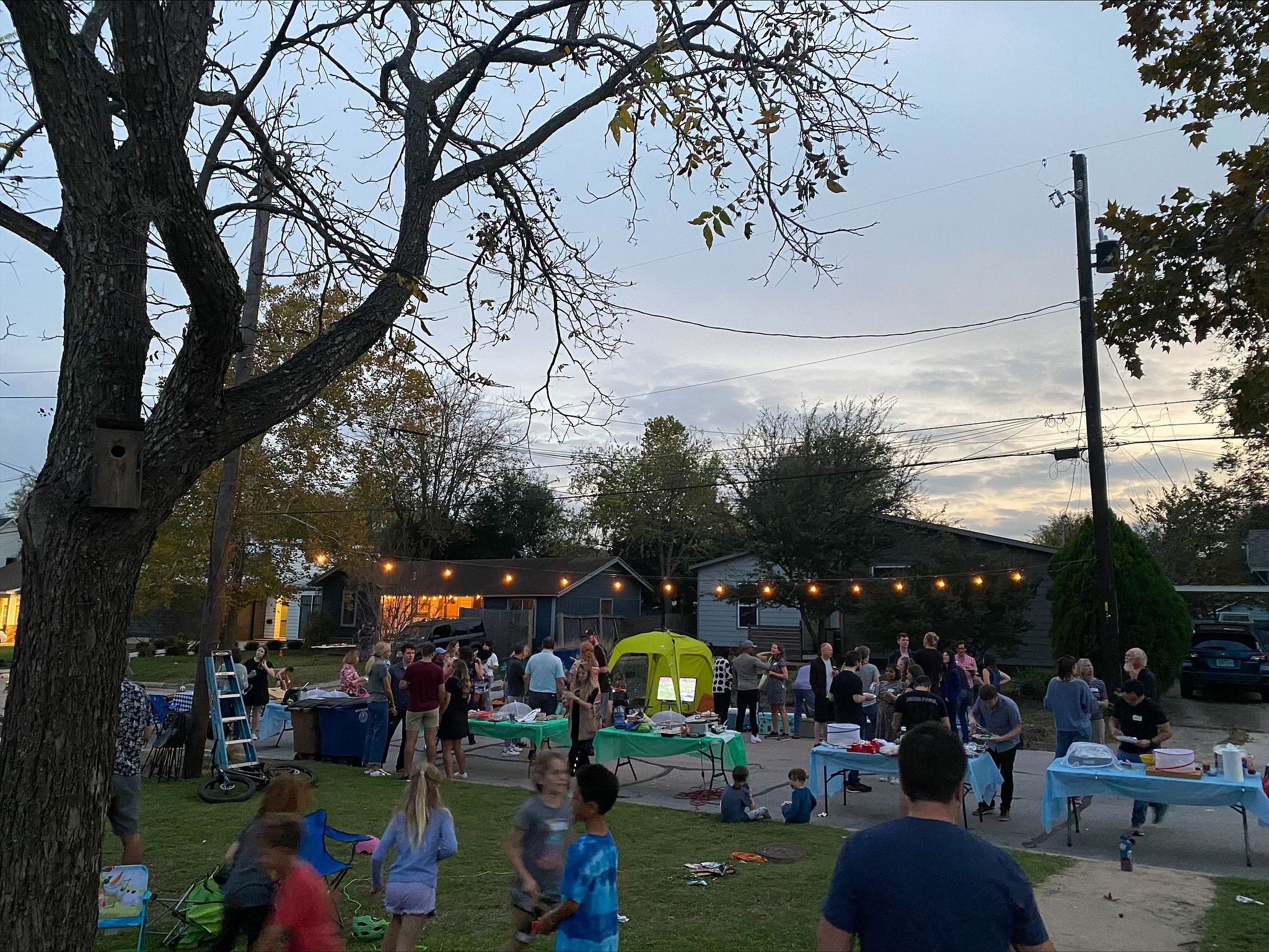 Residents gather outside during a block party 