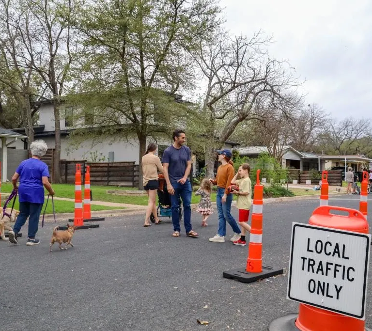 People walking with friends and pets on a Healthy Street in Austin.