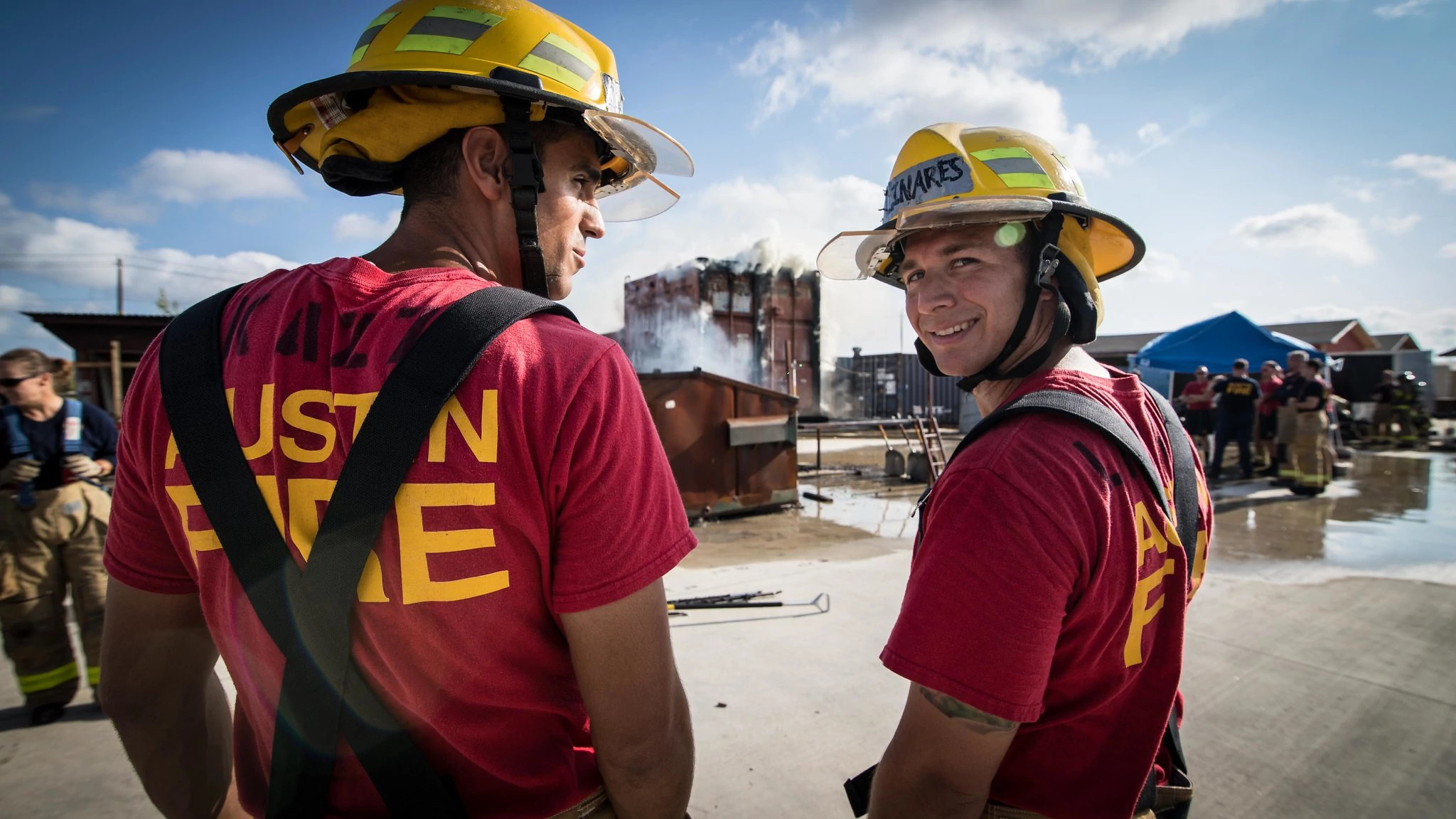 Two AFD firefighters standing together in uniform