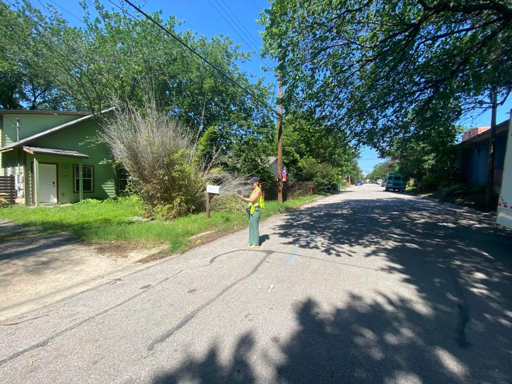A surveyor collecting information on a house from the public right of way