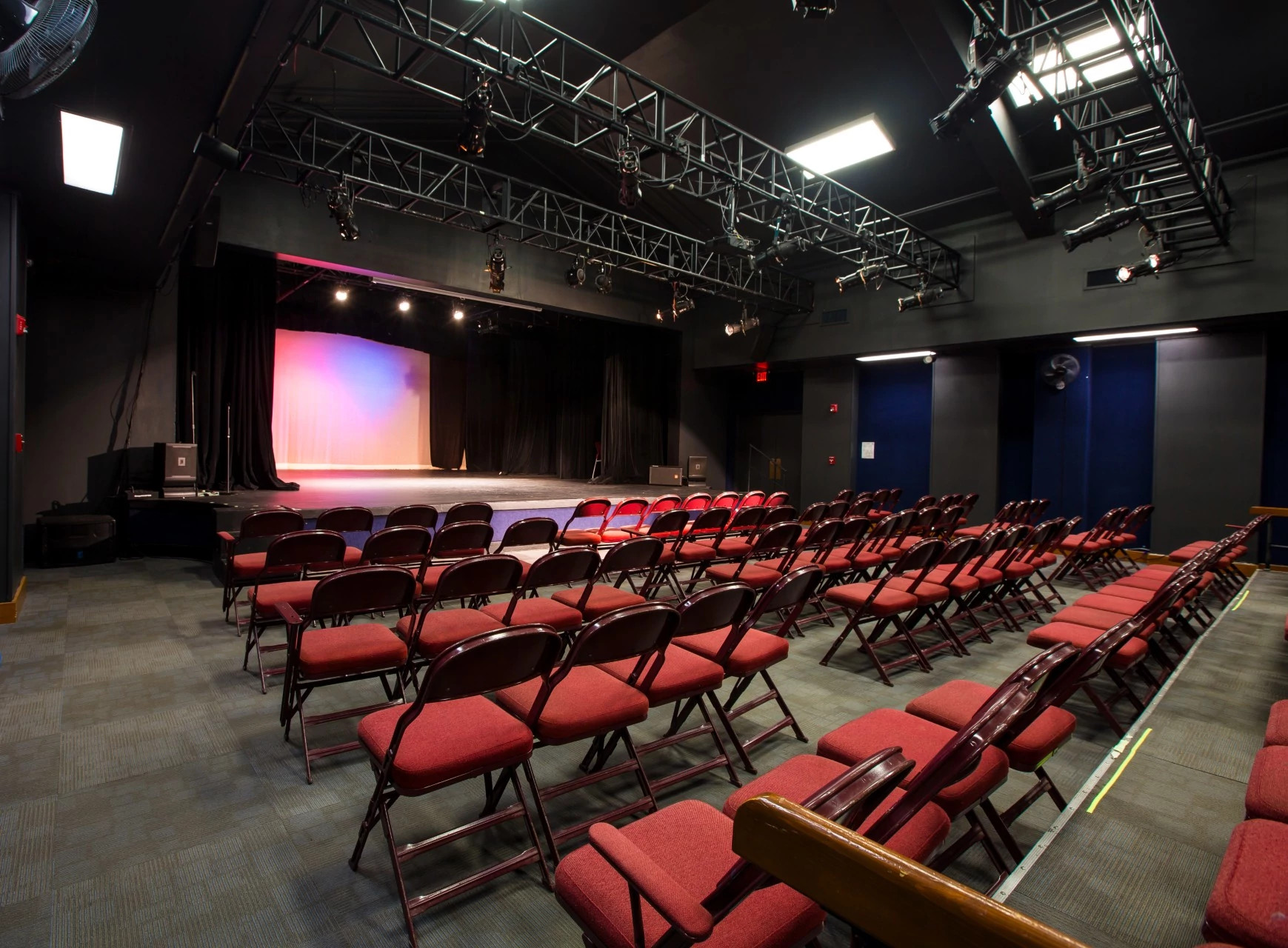 A large theater with a percinium style theater and seating.