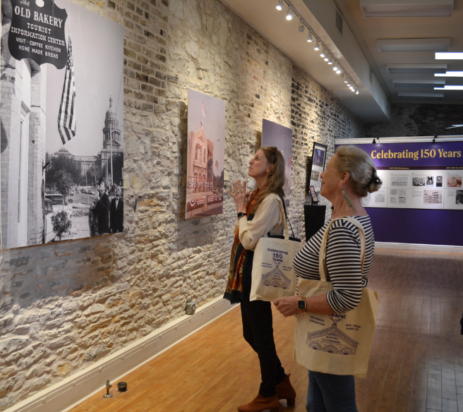 two women looking at historic photo