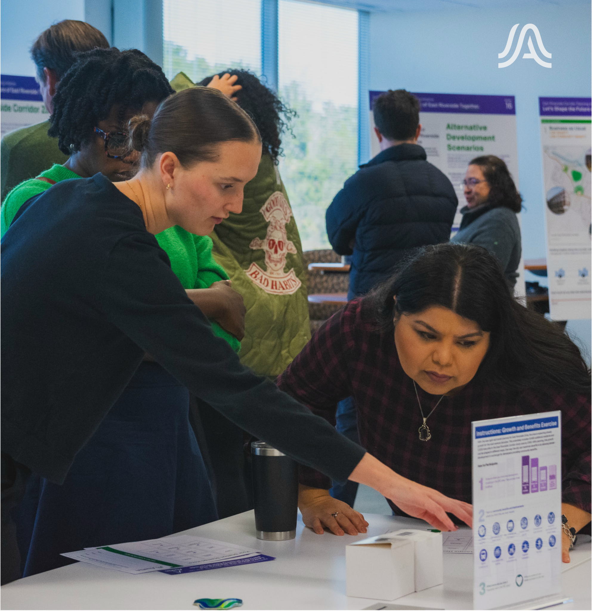 A group of people working at a table 