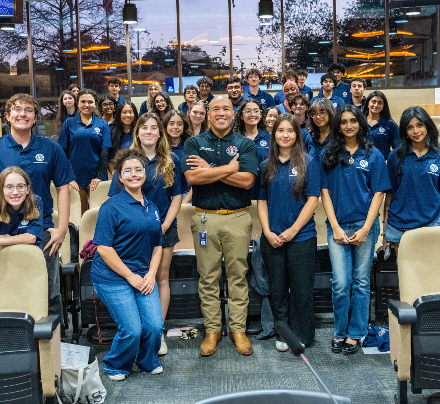 a group of youth gathers around City Council Member Jose Velasquez in City Hall