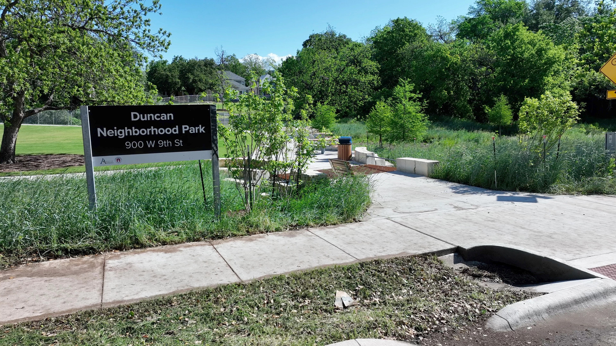 The entry sign to Duncan Neighborhood Park, showcasing paved walkways and new landscaping