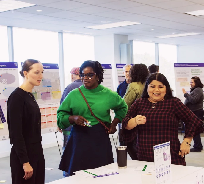 Women talking at a community event for Grove-Riverside.