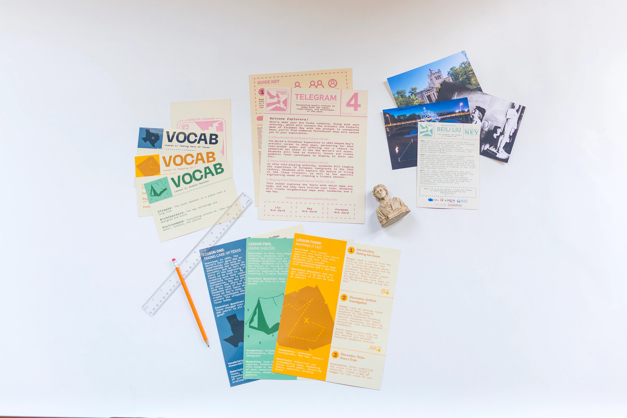 Colorful activity sheets and drawing materials on a white background
