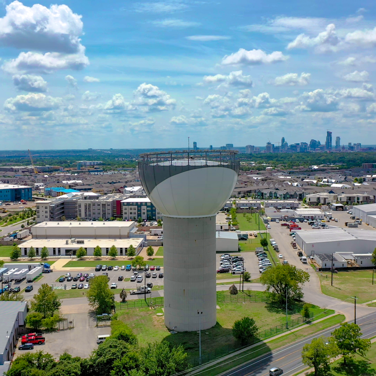 A view of Austin Water's Reclaimed Water tower facility with the Austin skyline visible in the background