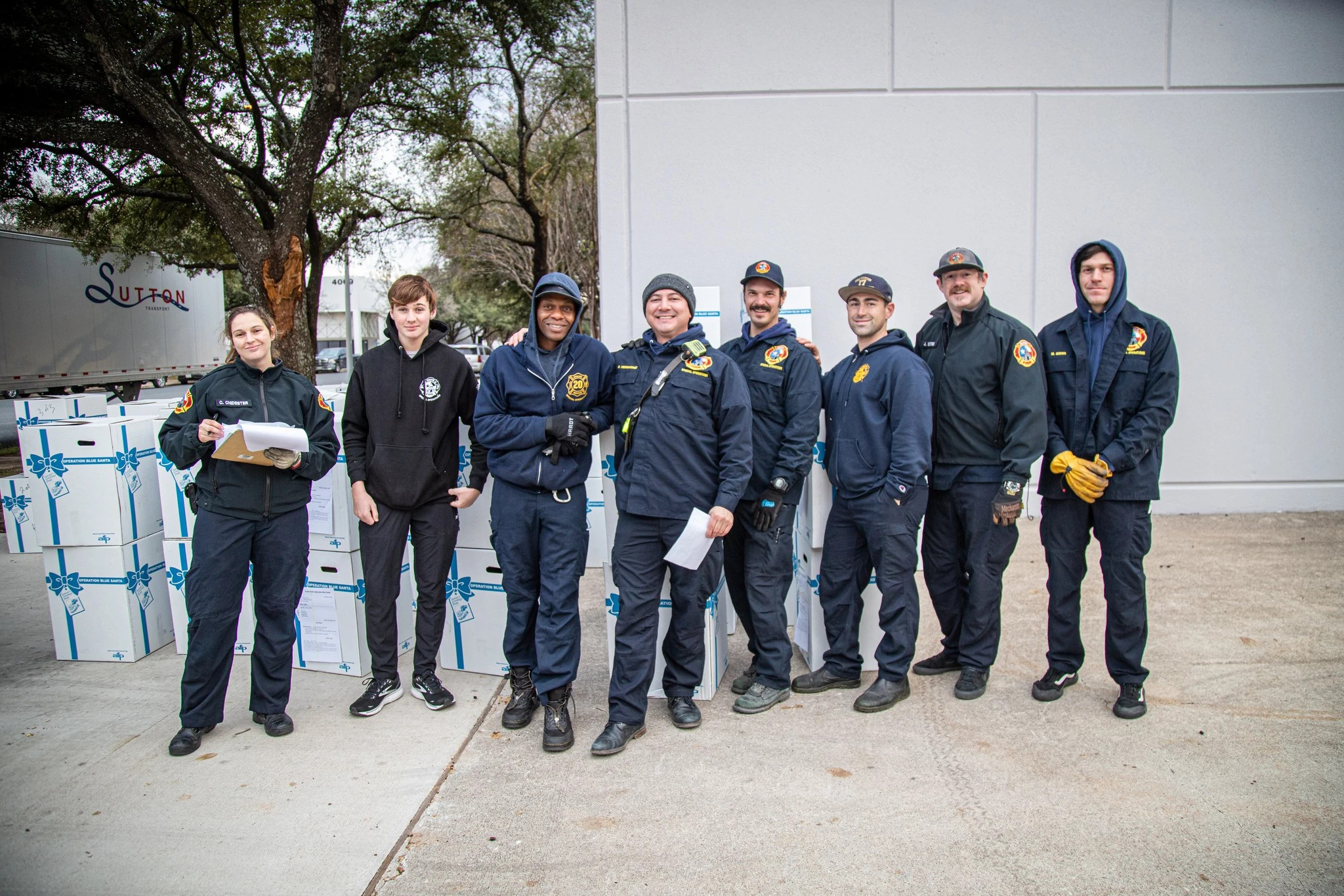 8 AFD employees smiling in uniform