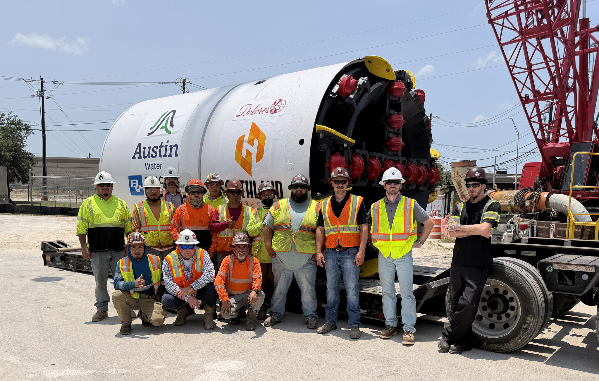 The construction crew for Austin Water's McNeil Transmission Main project posing in front of Dolores, the project's tunnel boring machine or TBM