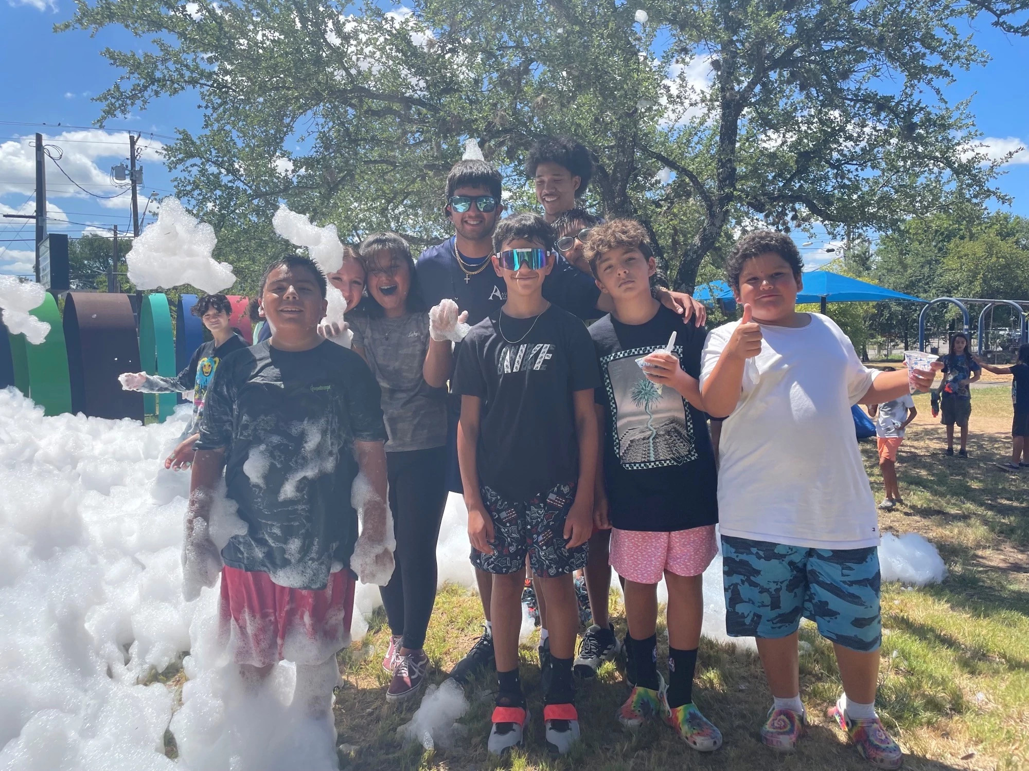 Group of kids at a park posing for a photo
